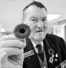  ?? MELINDA CHEEVERS NIAGARA THIS WEEK ?? David Hagan holds up a poppy inside Royal Canadian Legion Branch 24 in St. Catharines.