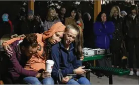  ?? PHOTOS BY ERIC ALBRECHT / THE COLUMBUS DISPATCH ?? Bobbie Simpson’s friends pray for her at her vigil on Thursday. “She was a good girl, an honor roll student,” her mother said.