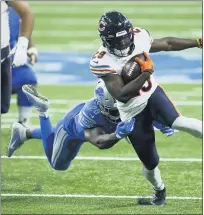  ?? DUANE BURLESON — THE ASSOCIATED PRESS ?? Chicago Bears running back Tarik Cohen (29) tries to break the tackle of Detroit Lions strong safety Duron Harmon (26) in the first half of a Sept. 13game in Detroit.