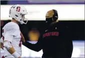  ?? ELAINE THOMPSON — THE ASSOCIATED PRESS ?? Stanford coach David Shaw, right, talks with quarterbac­k Davis Mills during a timeout in the second half against Washington last week. Stanford will be without four starters because of injuries against Oregon State on Saturday.