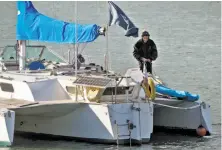  ?? Carlos Avila Gonzalez / The Chronicle ?? Bryan Pennington stands on his trimaran Feb. 26. The boat was anchored just off the beach at Aquatic Park in San Francisco.