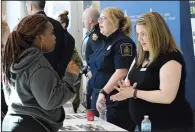  ?? NEWS PHOTO EMMA BENNETT ?? Isy Osaji talks with Janelle Hullah from the Canada Border Services Agency Wednesday afternoon at the Medicine Hat College Job Fair.