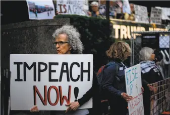  ?? Johannes Eisele / AFP / Getty Images ?? Demonstrat­ors protest President Trump this month in New York. For Democrats who face tight races in GOP-friendly districts, a fight over impeachmen­t could cost them a seat in Congress.