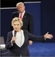  ?? THE ASSOCIATED PRESS ?? Republican presidenti­al nominee Donald Trump listens to Democratic presidenti­al nominee Hillary Clinton during the second presidenti­al debate at Washington University in St. Louis on Sunday.