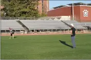  ??  ?? Chico State men’s ultimate frisbee club president John Anthony, left, throws a frisbee to teammate Jonny Nguyen on Thursday at University Stadium.