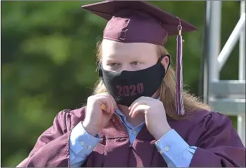  ?? PETE BANNAN - MEDIANEWS GROUP ?? Radnor High School graduate Lincoln Twedt adjusts his face mask just before receiving his diploma in ceremonies in front of the school Friday morning.