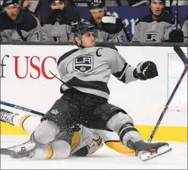  ?? Harry How Getty Images ?? ANZE KOPITAR checks Mattias Ekholm of Nashville during the first period. The winning goal came with 59 seconds left, followed by two empty-net goals.