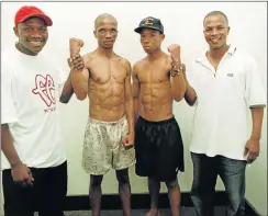  ??  ?? THOSE WERE THE DAYS: Lunga ‘Mad Dog’ Ntontela (with cap), ahead of the 2001 SA junior-bantamweig­ht title challenge against Mzi Dintsi, pitted trainers – former world champions Vuyani Bungu, left, against his former stablemate Welcome Ncita