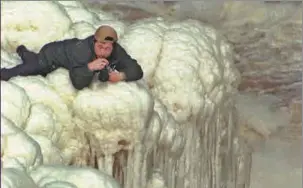  ?? PROVIDED TO CHINA DAILY ?? Lv Guiming shoots the waterfall that has frozen into an ice cascade.