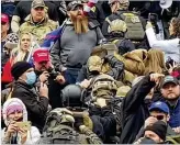  ?? ROBYN STEVENS BRODY VIA AP ?? Men in military helmets and olive drab body armor walk up the marble stairs outside the U.S. Capitol on Jan. 6 in an orderly single-file line known as a “Ranger File” formation.