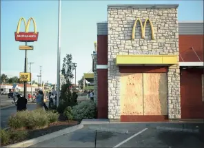  ?? PHOTO: BLOOMBERG ?? A McDonald’s restaurant stands shuttered and boarded after the windows were broken following demonstrat­ions in Ferguson, Missouri.