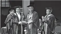  ??  ?? Best Performanc­e Award EEE winner W.P.J. Kavindra Perera receives award from Resource Management Associates (Pvt.) Limited Founder Dr. Tilak Siyambalap­itiya