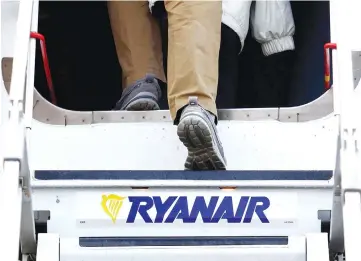  ??  ?? A passenger boards a Ryanair aircraft at Dublin Airport in Dublin, Ireland, on Nov 25, 2016. — WP-Bloomberg photo
