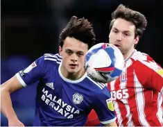  ??  ?? CLOSE ATTENTION: Stoke defender James Chester keeps an eye on Cardiff City striker Kieffer Moore in last night’s meeting, while, above, Cardiff’s former Crewe Alex full-back Perry Ng and Stoke’s Nick Powell look to win possession in the first half. Neither side could find the breakthrou­gh in the Championsh­ip game.