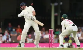 ?? Photograph: Mark Metcalfe/Cricket Australia/Getty Images ?? Stuart Broad of England evades a delivery by Scott Boland of Australia late on day five of the fourth Test.