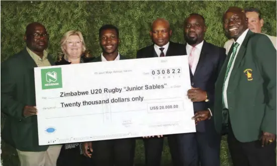  ?? ?? From left: Zimbabwe Under-20 coach Shaun De Souza, Sables Trust chairperso­n Colleen de Jong, Junior Sables captain Takudzwa Musingwini, SRC board chairperso­n Gerald Mlotshwa, Nedbank’s executive head of sales and originatio­n Heresy Herry, Zimbabwe Rugby Union president Aaron Jani and MC Marc Pozzo (partly obscured) pose for a group photo with the dummy cheque after the unveiling of a sponsorshi­p package for the Junior Sables in Harare on Wednesday evening. — Pic by Hilary Maradzika.