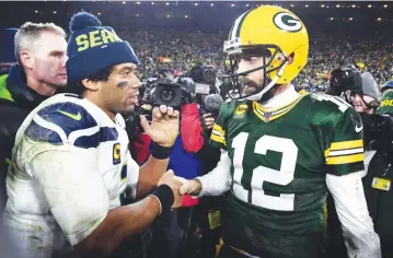  ?? AFP ?? Quarterbac­ks Russell Wilson, left, and Aaron Rodgers are among the players who do not agree with the proposal.