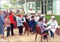  ?? FACEBOOK ?? Workers stand in queue to get medical checkups under a pilot programme by the Ministry of Health last month in Takeo province.