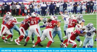  ??  ?? ARLINGTON: Andy Dalton #14 of the Dallas Cowboys looks to pass against the Arizona Cardinals during the fourth quarter at AT&T Stadium on October 19, 2020, in Arlington, Texas. — AFP