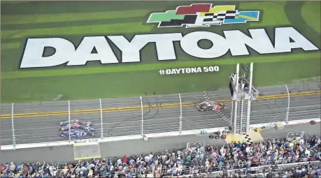  ?? Phelan M. Ebenhack / AP ?? Austin Dillon (3) takes the checkered flag to win the Daytona 500 race at Daytona Internatio­nal Speedway on Sunday afternoon in Daytona Beach, Fla.