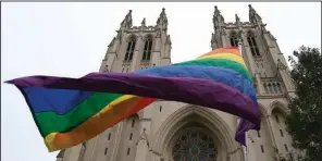  ?? AP/CAROLYN KASTER ?? A gay pride flag flies Friday outside the Washington National Cathedral after an interment service for Matthew Shepard, who was slain in Wyoming in 1998.