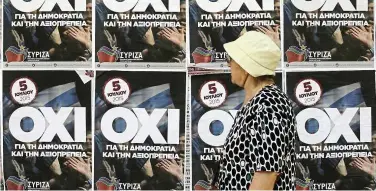  ??  ?? 50-50 chance: A pedestrian passing ‘OXI’ or ‘No’ campaign posters against the bailout proposals on a street in Thessaloni­ki. Greece is divided right down the middle regarding the referendum on European bailout proposals. — Bloomberg