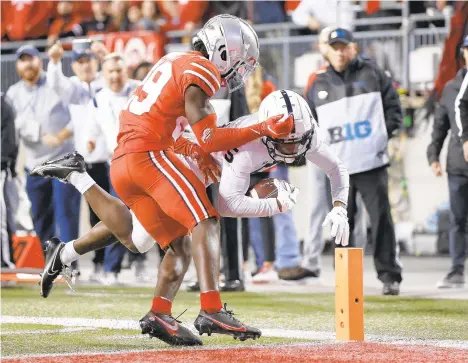  ?? JAY LAPRETE/AP ?? Penn State receiver Jahan Dotson scores a touchdown past Ohio State defensive back Denzel Burke during the second half Saturday night in Columbus, Ohio. It was the first rushing touchdown of the Nazareth High School graduate’s Penn State career.