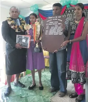  ??  ?? From Left: Commission­er Northern Jovesa Vocea, Tabucola Valibar Sangam Primary School headgirl Shiviya Ram holding the Outstandin­g Student of the Year award standing with her parents Prabhu Ram and Sanyogita Devi during the prizegivin­g in Labasa on November 16, 2018.