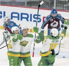  ?? Stacy Bengs, The Associated Press ?? Minnesota’s Jonas Brodin, front left, celebrates with teammates Joel Eriksson Ek and Jordan Greenway (18) after scoring the winning goal in overtime.