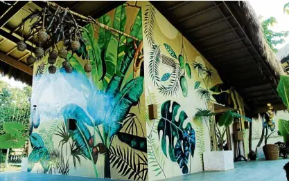  ??  ?? Tropical-inspired murals make an Instagram-worthy backdrop.