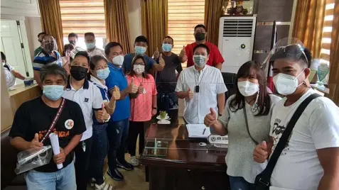  ?? (Chris Navarro) ?? LEGISLATOR­S ALL. Mabalacat City Vice-Mayor Geld Aquino and Councilor Jun Castro flash the thumbs up sign with barangay kagawads of Dau, Dolores, Duquit, Mabiga and Macapagal, during Monday's visit to the Office of the Vice Mayor.
