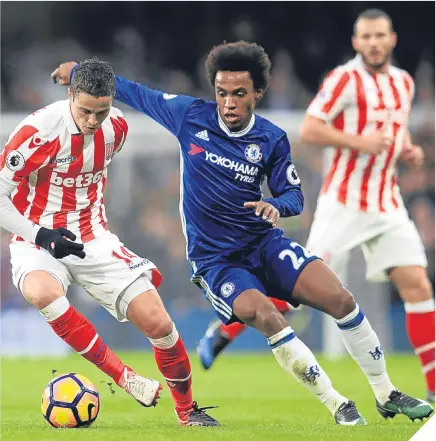  ??  ?? ■ Stoke City’s Ibrahim Afellay (left) and Chelsea’s Willian (right) battle for the ball at the Bridge.