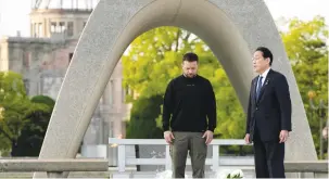  ?? (Eugene Hoshiko/Pool via Reuters) ?? UKRAINIAN PRESIDENT Volodymyr Zelensky and Japanese Prime Minister Fumio Kishida talk after laying flowers in front of the Cenotaph for the Victims of the Atomic Bomb at the Hiroshima Peace Memorial Park yesterday.