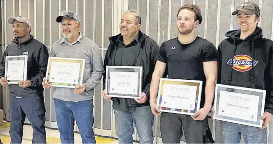  ?? KASTIN BRADLEY ?? Graduates of the recent Pathways to Success program include, from left, Gutu Wago, Sayed Hagar, Ayman Aly, Chase MacIntyre and Brandon Carson. The program provides individual­s with entry-level knowledge and training as a tire and maintenanc­e technician.