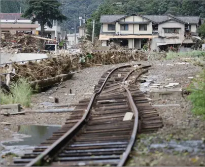  ?? Photo: Nampa/AFP ?? Torrential…The rails of a railway track lay twisted and damaged from flooding caused by torrential rains in Yatsushiro, Kumamoto.