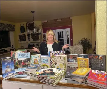  ?? SUBMITTED PHOTOS ?? Mandy Marquez coordinate­d this year’s book project for Soroptimis­t Internatio­nal of Eureka. She’s pictured with some of the books that have been donated to local middle schools.