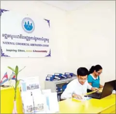  ?? PHA LINA ?? Staff of the National Commercial Arbitratio­n Centre are seen at work last year at its office in Phnom Penh.