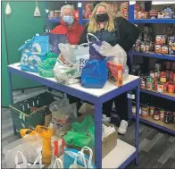  ?? ?? Mhairi Hendrie from The Picture House delivers the canned donations to food bank volunteer Mhairi Reid.