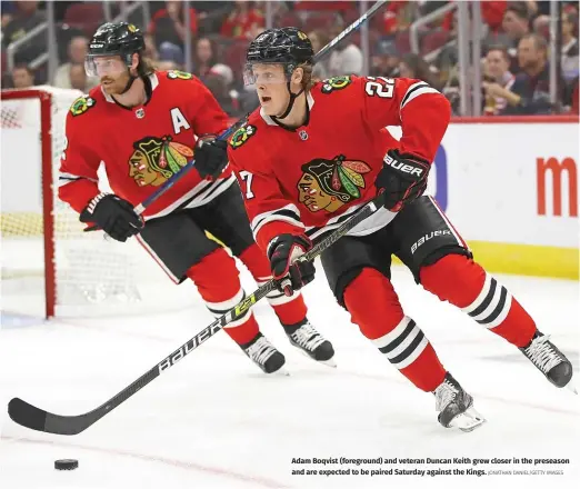  ?? JONATHAN DANIEL/GETTY IMAGES ?? Adam Boqvist (foreground) and veteran Duncan Keith grew closer in the preseason and are expected to be paired Saturday against the Kings.