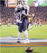  ?? JACK DEMPSEY/ASSOCIATED PRESS ?? New England running back James White (28) celebrates his touchdown with tight end Rob Gronkowski on Sunday. The Patriots have won 12 straight road games.