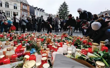  ??  ?? PEOPLE attend a ceremony for the victims of a fatal car incident at Porta Nigra in Trier, Germany. According to reports, five people died, including a 9-week-old baby, and at least 15 were injured after a car ploughed into pedestrian­s on Tuesday. Police arrested the driver, a 51-year-old local man, who was found to have drunk a significan­t amount of alcohol.