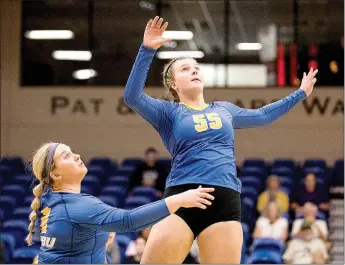  ?? Photo courtesy of JBU Sports Informatio­n ?? John Brown’s Taylor Golmen (No. 55) goes up for a hit against Central Christian (Kan.) on Sept. 7 as Morgan Fincham (left) looks on. The Golden Eagles defeated Mid-America Christian 3-1 on Thursday, Sept. 22, and Science & Arts 3-0 on Saturday, Sept. 24. JBU is back in action Friday, Sept. 30, at Southweste­rn Assemblies of God.