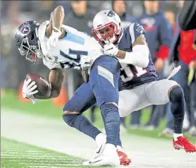  ?? MATT STONE / BOSTON HERALD FILE ?? Patriots cornerback Jonathan Jones pulls Titans receiver Corey Davis out of bounds during the fourth quarter of a Wild Card game at Gillette Stadium on Jan. 5.