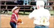  ?? MARK HUMPHREY ENTERPRISE-LEADER ?? Profession­al rodeo photograph­er Pam Baldridge, of Fayettevil­le, gets a close-up during the 64th annual Lincoln Rodeo stick horse grand entry with Ethan Parker, newlycrown­ed 2017 Lincoln Riding Club Lil’ Mister, leading the grand entry during last year’s Lincoln Rodeo. The 2018 Lincoln Rodeo is co-sanctioned by the ACRA and IPRA.