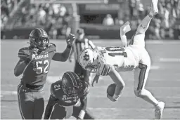  ?? SEAN RAYFORD/AP ?? Auburn quarterbac­k Bo Nix is knocked out of bounds by South Carolina defensive back Shilo Sanders (21) and Kingsley Enagbare (52).