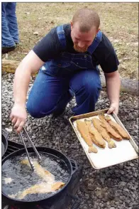  ?? PHOTOS BY KEITH SUTTON/CONTRIBUTI­NG PHOTOGRAPH­ER ?? Dennis Coker at Gaston’s White River Resort prepares a noontime meal of fresh trout for guests fishing with guides who work at this world-famous trout-fishing destinatio­n.