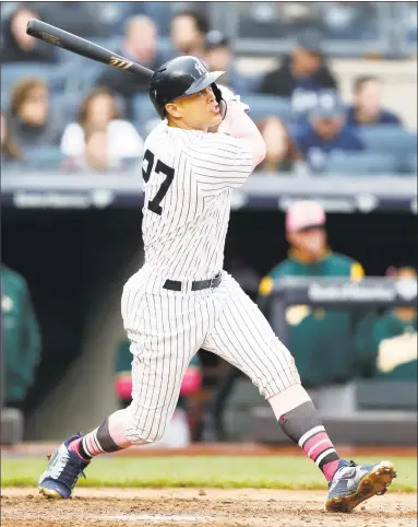  ?? Kathy Willens / Associated Press ?? Giancarlo Stanton watches his fifth-inning solo home run against the Athletics on Sunday in New York.