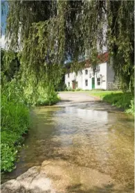  ??  ?? The glistening waters of a clear ford on a peaceful road at Tealby Thorpe.