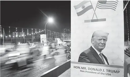  ?? AIJAZ RAHI/AP ?? Drivers on Sunday ride on a decorated bridge in Ahmedabad, India, that President Trump is expected to cross during his visit this week.