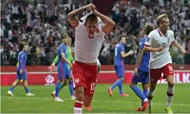  ?? Czarek Sokołowski/AP ?? Damian Szymanski celebrates Poland’s late equaliser against England in Warsaw. Photograph: